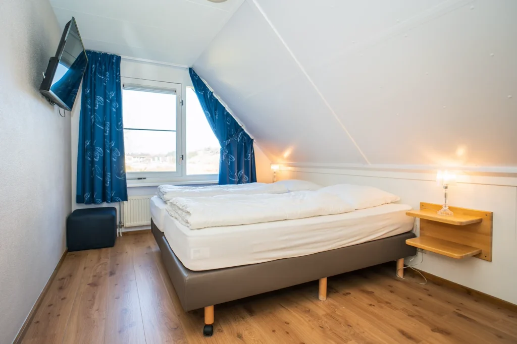 Slaapkamer in vakantievilla Bosrandweg 308 op Texel